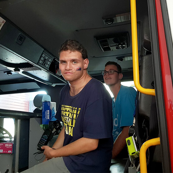 Two Access Support Coordination clients exploring a fire truck