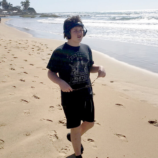 Young person with SCSS carer enjoying a day out at the beach